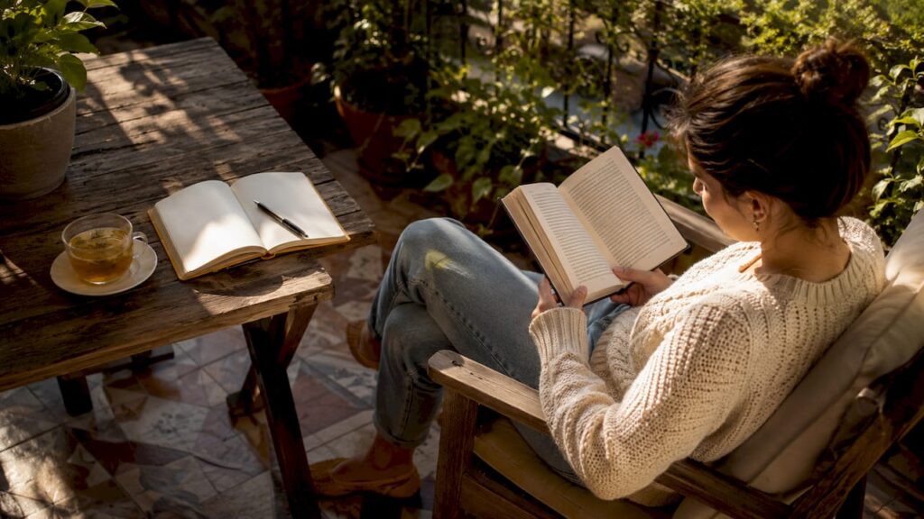 Person reading a book in a cozy living room