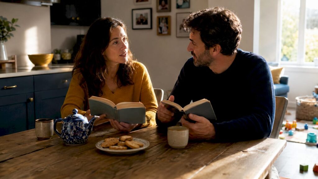 Couple reading co-parenting books together at home