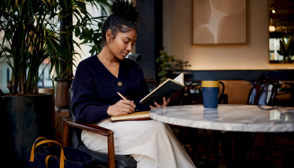 Woman reading productivity book in library