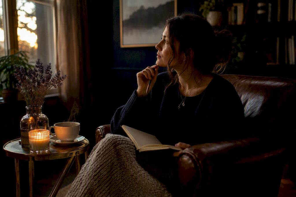 Woman journaling by candlelight