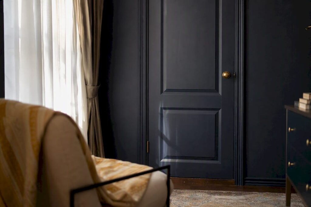Closed door with curtain casting shadows
