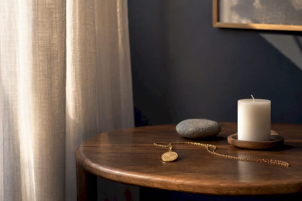Golden pendant and candle for healing